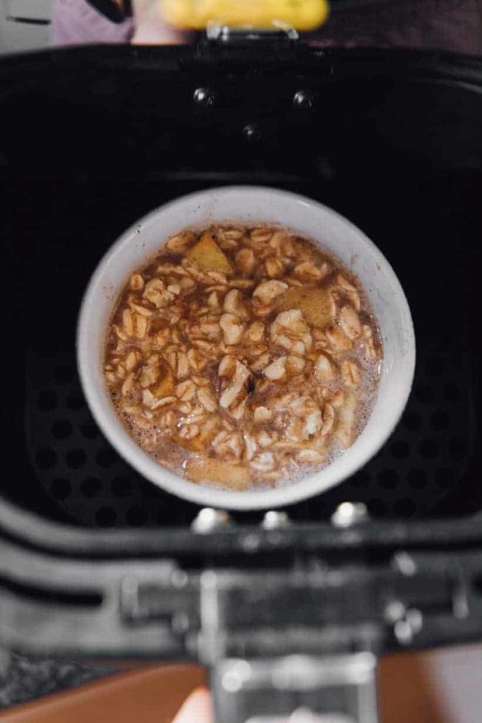 Place apple oatmeal in the air fryer basket. Make sure you use oven-safe containers.