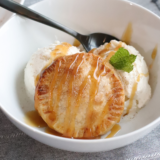 Air Fryer Caramel Apple Hand Pies served warm over a scoop of vanilla ice cream