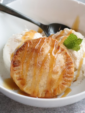 Air Fryer Caramel Apple Hand Pies served warm over a scoop of vanilla ice cream