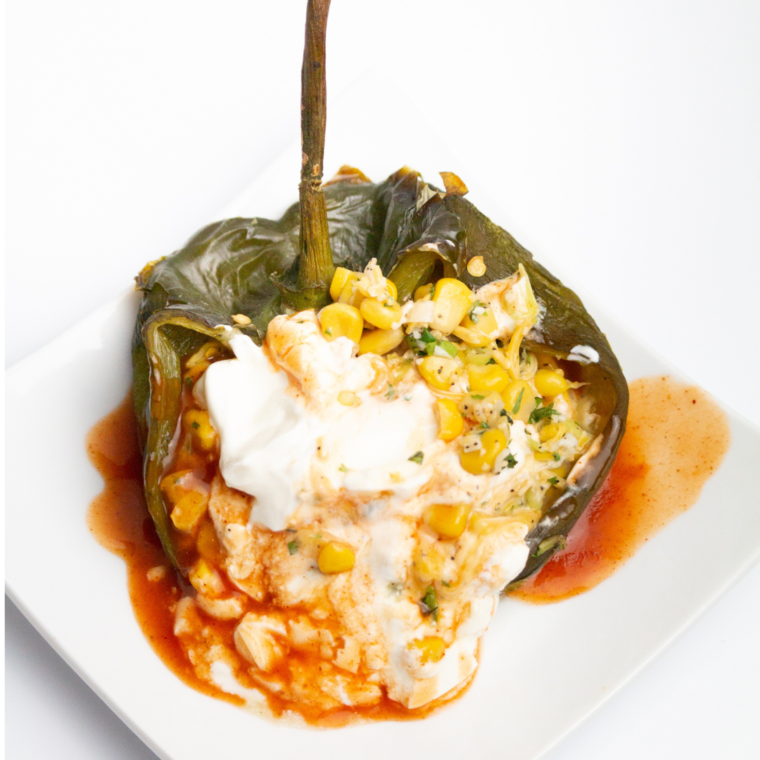 Crispy air fryer chile relleno stuffed with cheese and veggies, served golden brown on a plate.