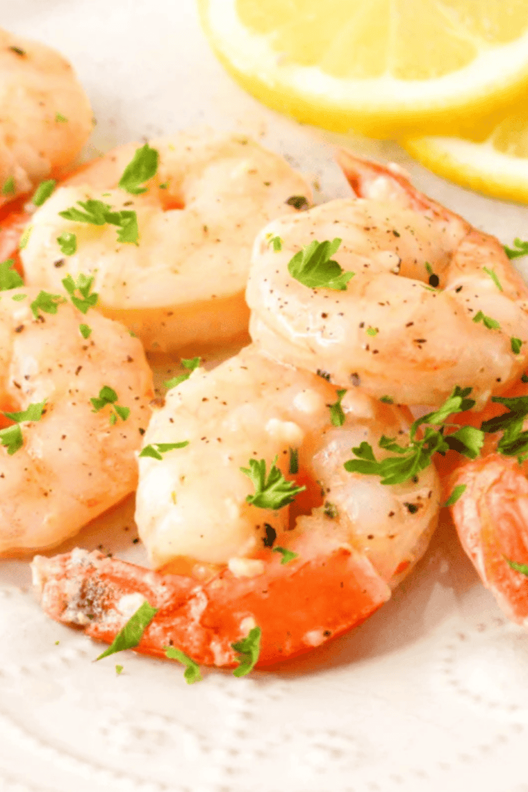 Raw shrimp tossed in melted garlic butter before air frying