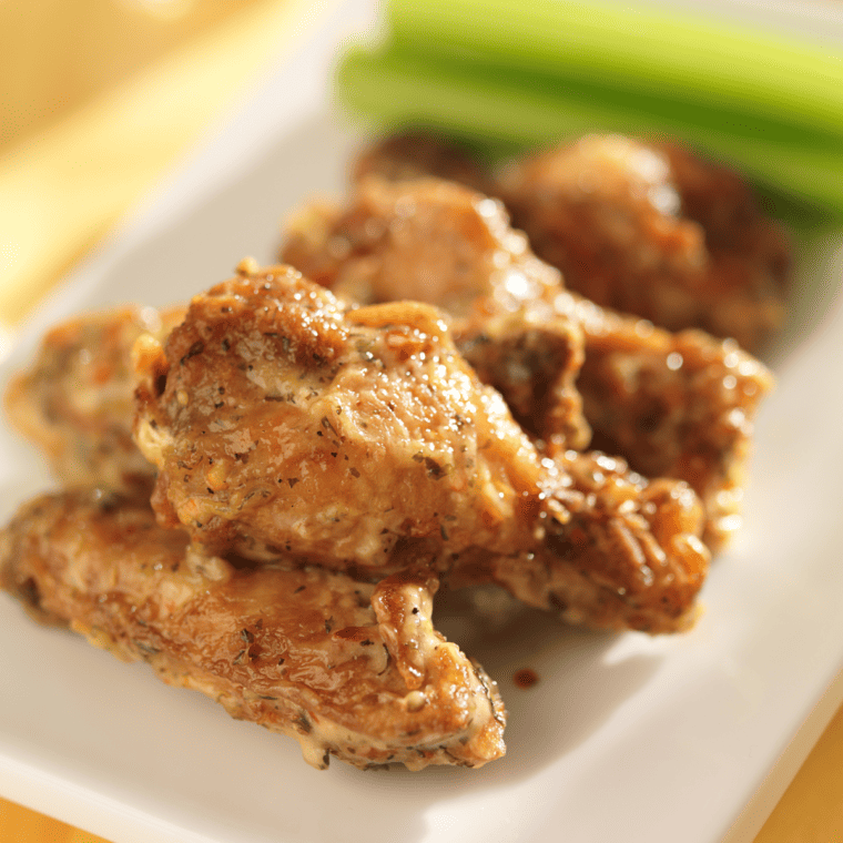 Buffalo Wild Wings Garlic Parmesan Wings served on a plate, showcasing their crispy texture and creamy garlic parmesan sauce."