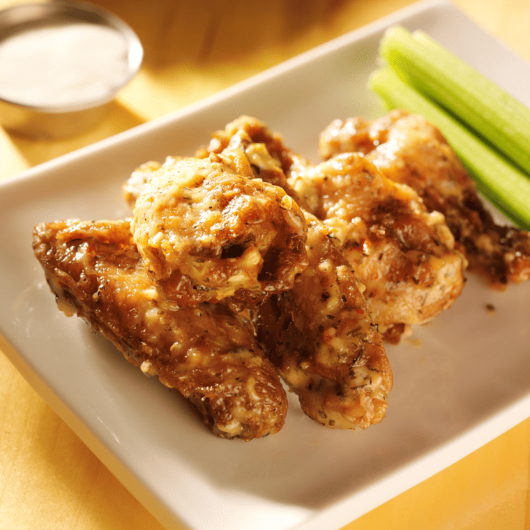Crispy Buffalo Wild Wings Garlic Parmesan Wings drizzled with creamy garlic and parmesan sauce, garnished with fresh parsley