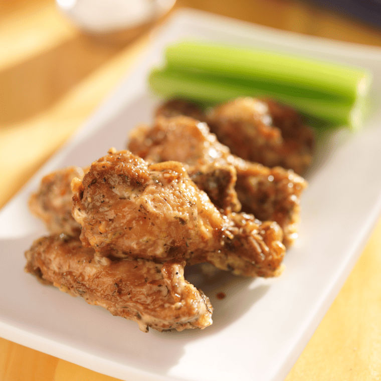 "Buffalo Wild Wings Garlic Parmesan Wings with creamy garlic sauce and Parmesan cheese on crispy chicken wings"