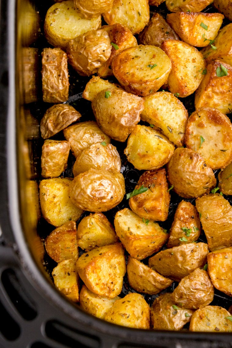 Close-up of golden rosemary potatoes with crispy edges