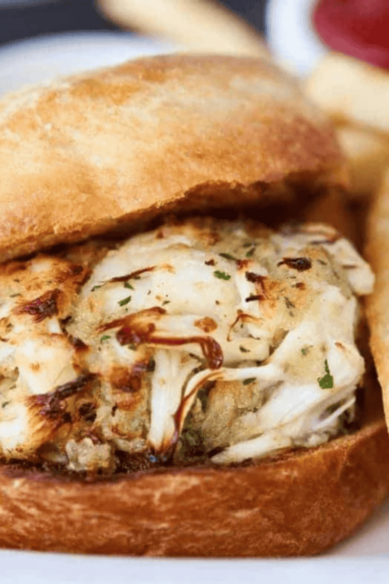 Golden brown crab cake sandwich made in air fryer with fresh toppings