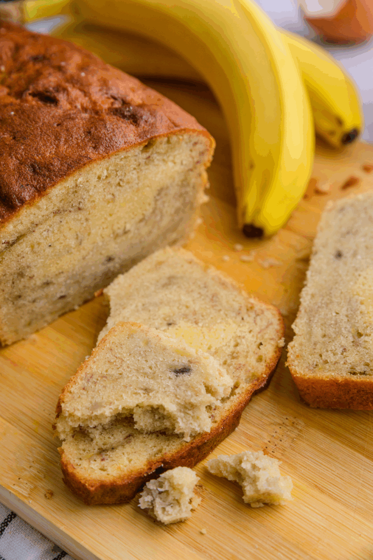Easy air fryer banana cake with golden top, sliced and served on a plate.
