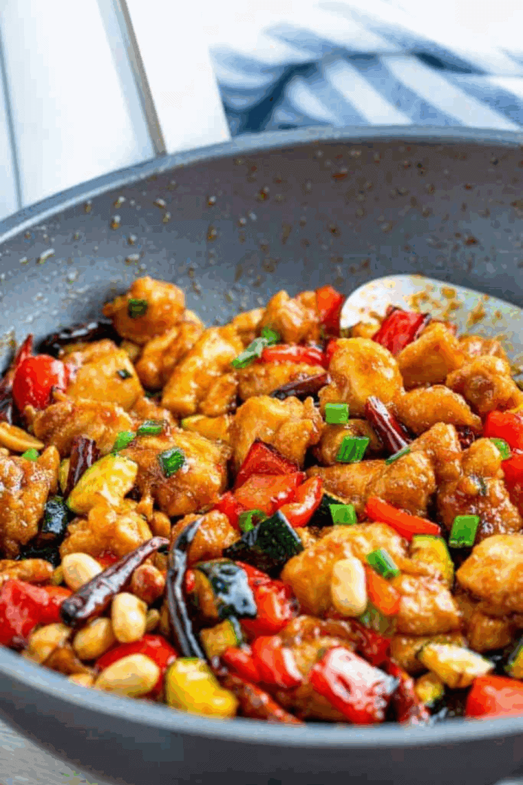 Chicken pieces in the air fryer basket, evenly spread and sprayed with olive oil, cooking at 400°F until golden and crispy.