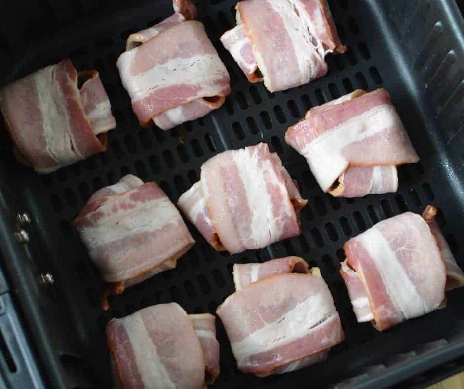 Bacon-wrapped Oreos secured with toothpicks, ready for the air fryer.