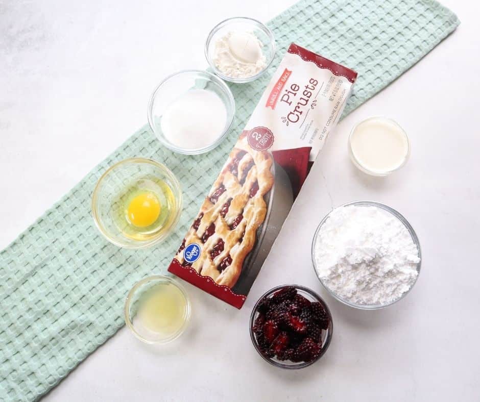 Ingredients Needed For Air Fryer Blackberry Hand Pies on white table with green towel.