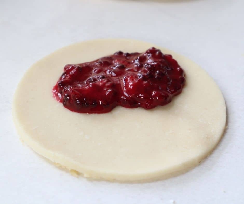 "Rolling out pie dough on a floured surface for hand pies"