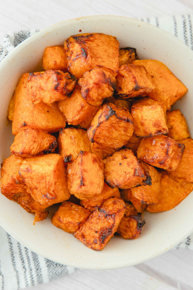 crispy air fryer butternut squash with sage thyme herbs on plate