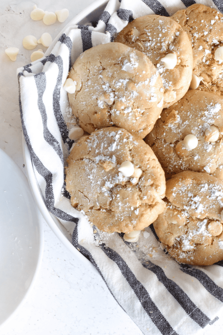 Freshly baked white chocolate chip cookies in the air fryer, soft centers with golden edges and melted white chocolate chips.