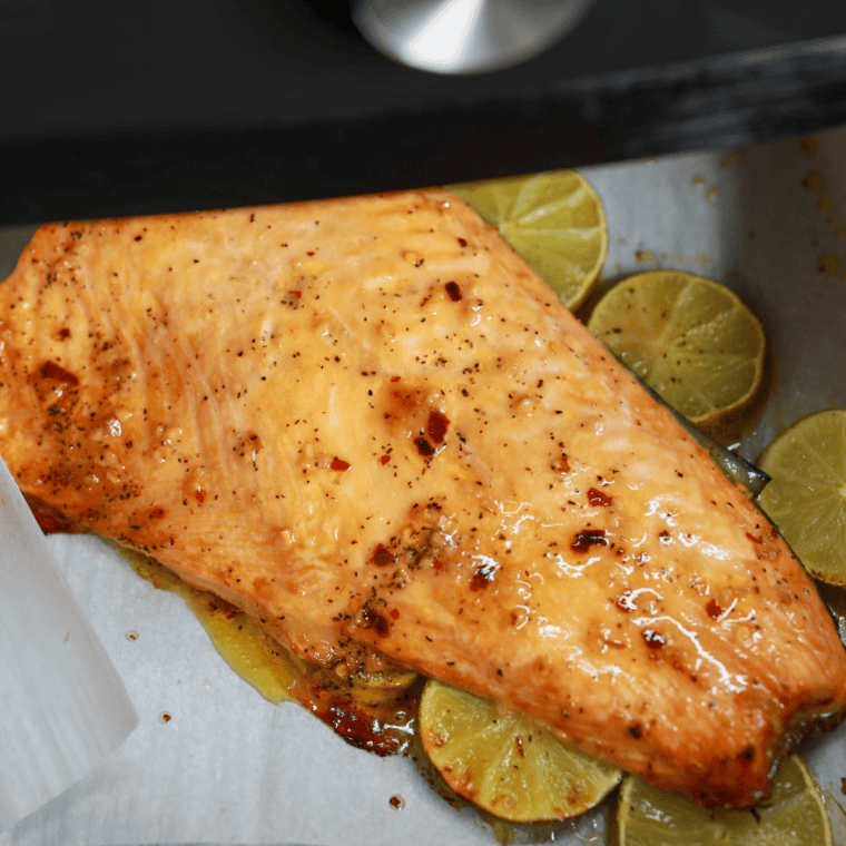 Cooked salmon fillets in the air fryer basket flaking at the thickest part