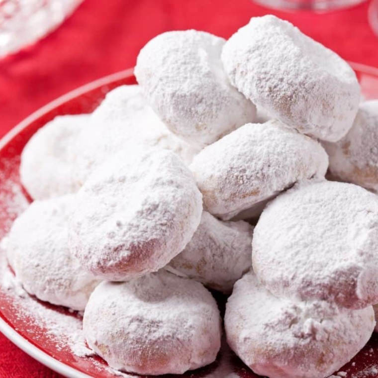Flattening Kourabiedes cookies with a spoon, air frying at 320°F, then cooling and coating with powdered sugar