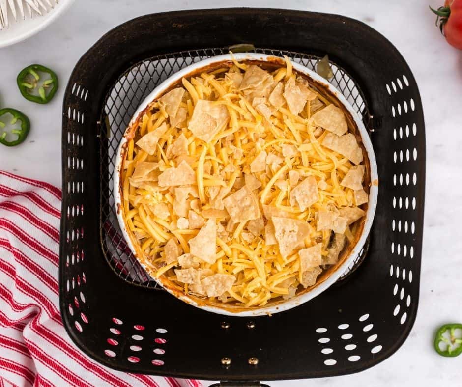 Air fryer Mexican chicken casserole cooking in the air fryer, bubbling and golden.