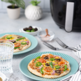 The easiest 5-minute weeknight pizza — a crispy pita bread crust, melty mozzarella, and any toppings you love, all cooked in your air fryer. No dough, no preheating an oven, no fuss.