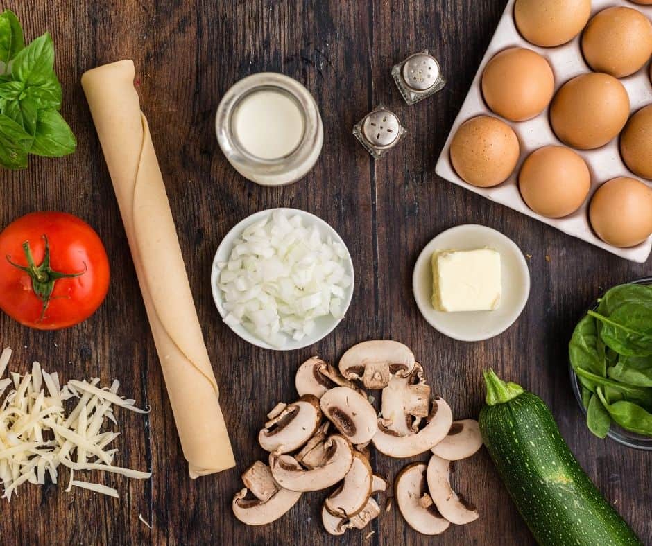 Ingredients Needed For Air Fryer Quiche Primavera on wooden kitchen table.