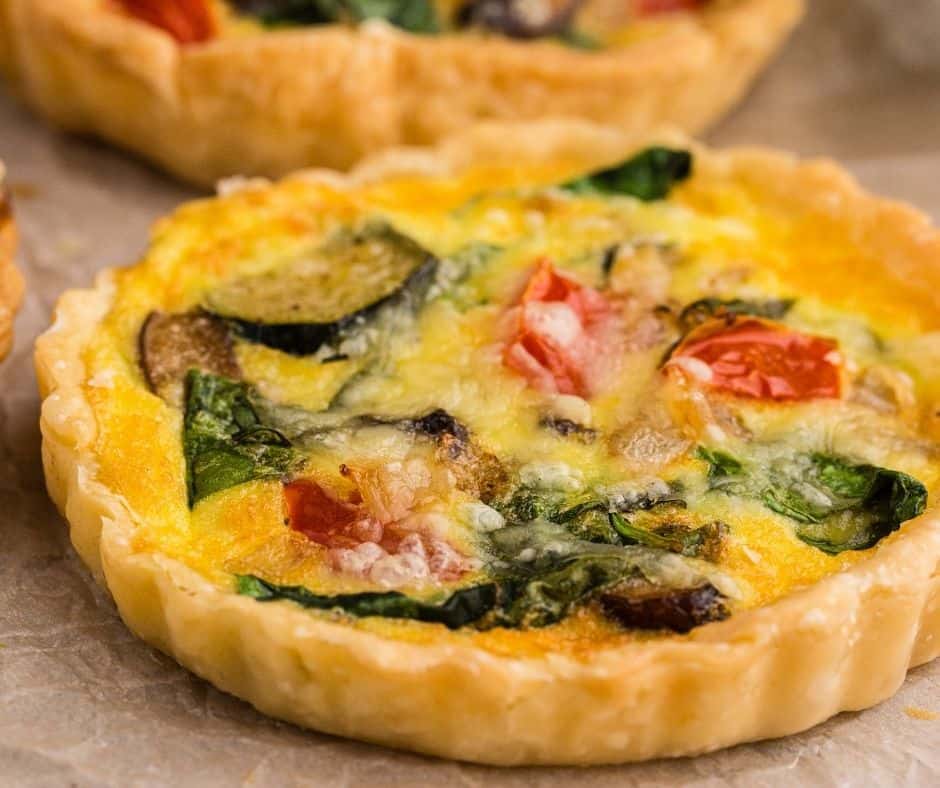 "Slice of Air Fryer Quiche Primavera with vibrant spring veggies"