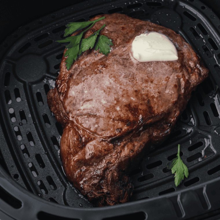 Sliced medium-rare air fryer ribeye steak showing pink, juicy center.