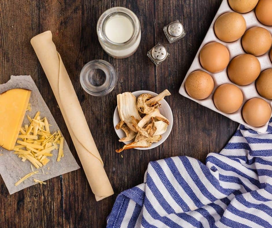 Ingredients Needed For Air Fryer Wild Mushrooms and Smoked Gouda Quiche on kitchen table.