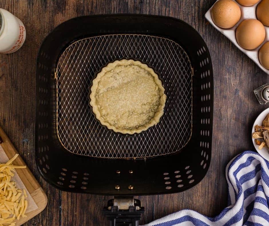 Blind bake the quiche crust in the air fryer basket.