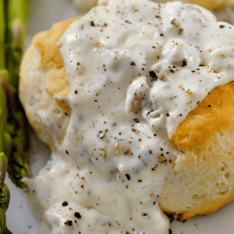 Cracker Barrel Sawmill Gravy Recipe served over biscuits.