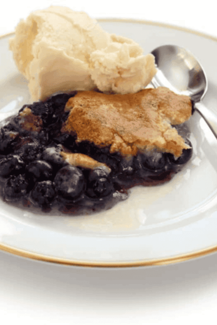 Air fryer blueberry cobbler served warm and ready to scoop, with golden topping and jammy filling