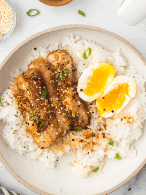Fluffy Instant Pot Coconut Jasmine Rice served in a bowl, garnished with herbs.