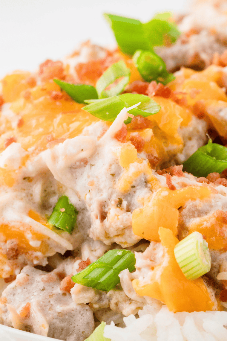 Instant Pot crack chicken with ranch cream cheese sauce, shredded cheddar, and crumbled bacon