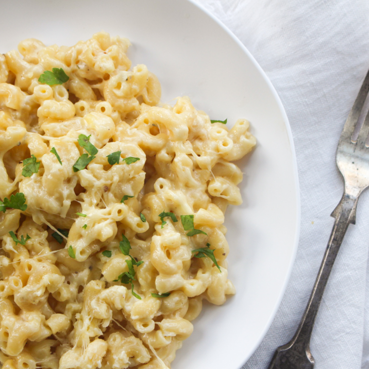 Close-up of copycat Panera white cheddar mac and cheese showing the glossy cheese sauce coating elbow macaroni