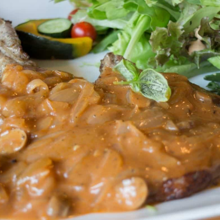 Instant Pot pork chops in creamy mushroom gravy, ready to serve.