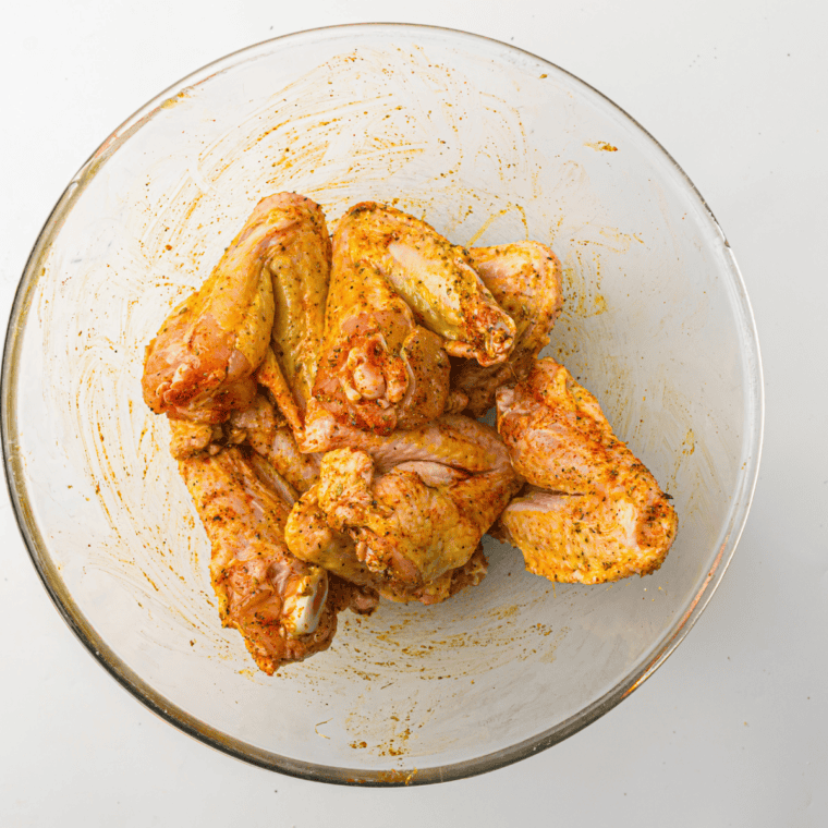 Chicken wings air frying in the Ninja Crispi glass container at 400°F