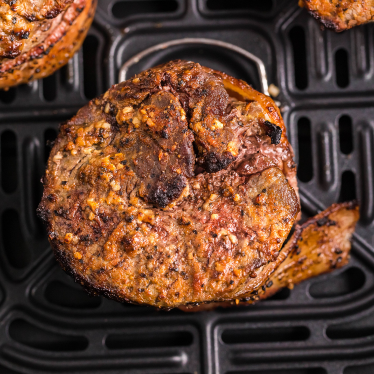 Air fryer basket heating up empty to 400°F to create a hot cooking surface for a proper sear.