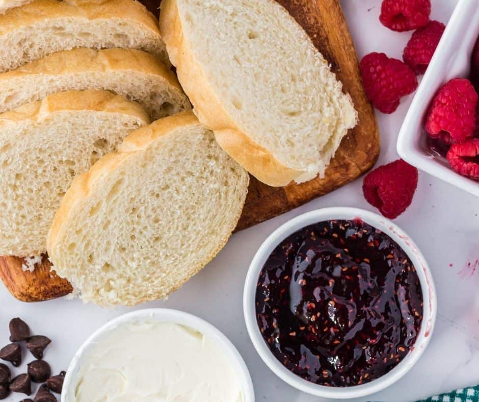 Ingredients needed for Air Fryer Chocolate Raspberry Mascarpone Sandwich on kitchen table.