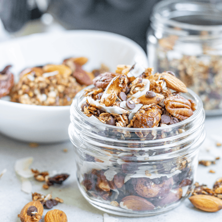 Crunchy homemade air fryer granola clusters in a white bowl.