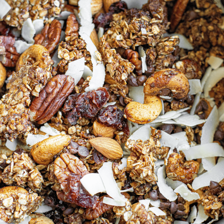 Golden air fryer granola served over yogurt with fresh berries