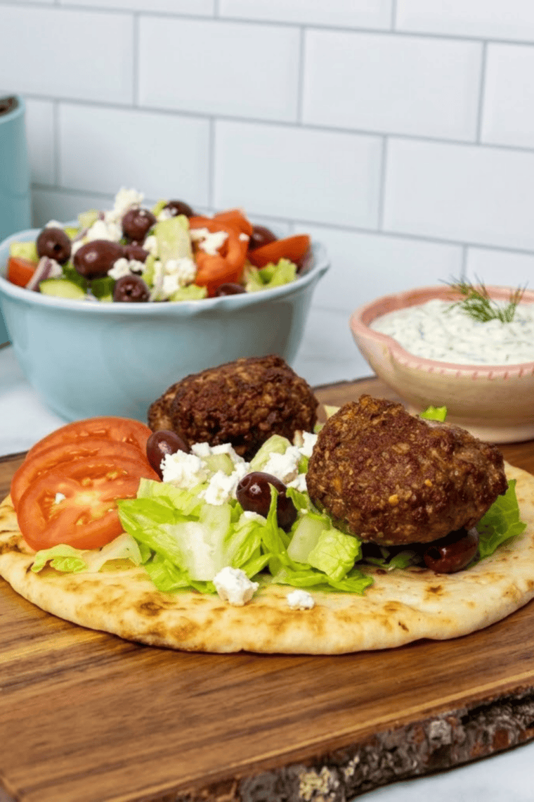 Air fryer lamb gyro in warm pita with tzatziki, tomatoes, and red onion