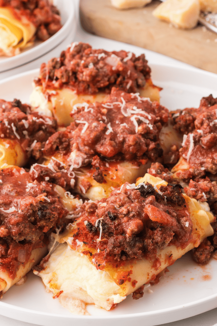 Golden and crispy Air Fryer Lasagna Rolls filled with ricotta, topped with marinara sauce and melted cheese.