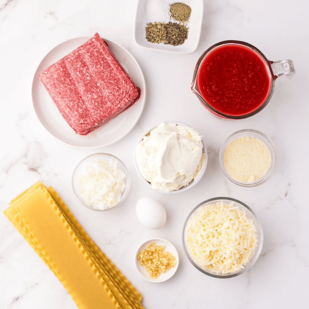 Ingredients needed for Air Fryer Lasagna Rolls on kitchen table.
