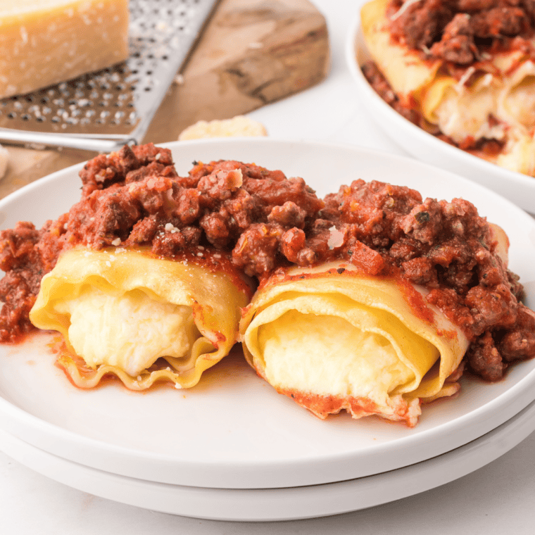 Golden, crispy Air Fryer Lasagna Rolls filled with ricotta and topped with marinara sauce and melted cheese.
