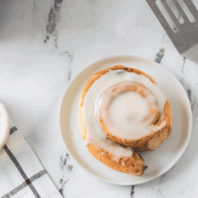 Fluffy Pillsbury cinnamon rolls baked in the air fryer and drizzled with icing.