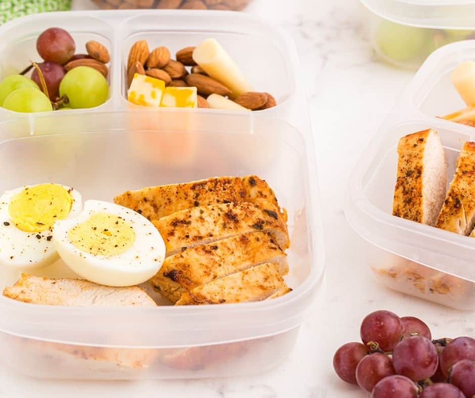 Homemade Protein Bistro Box with nutritious ingredients like chicken, eggs, and nuts.