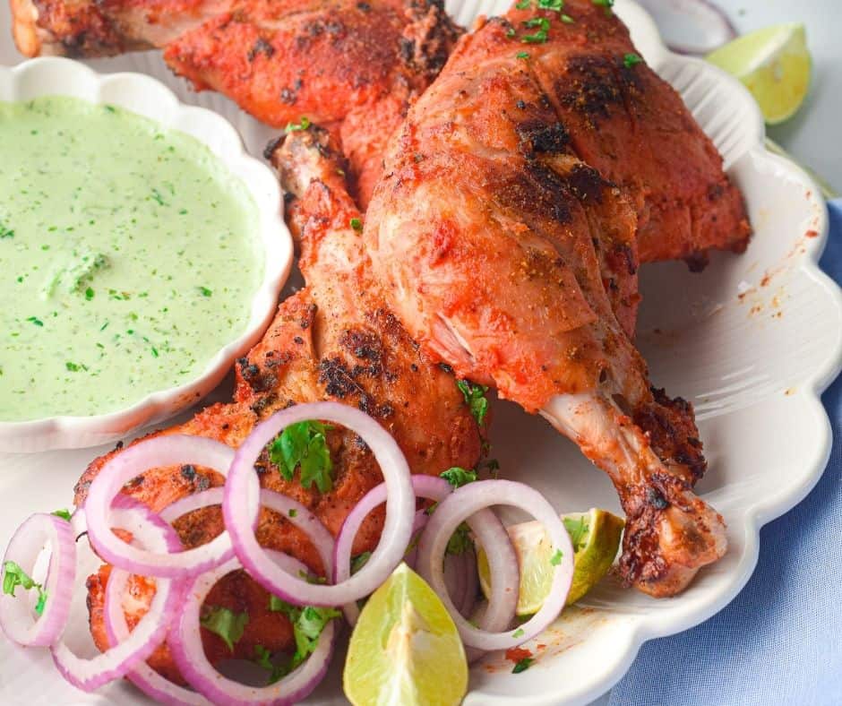 Plate of Air Fryer Tandoori Chicken with a sauce on the side.