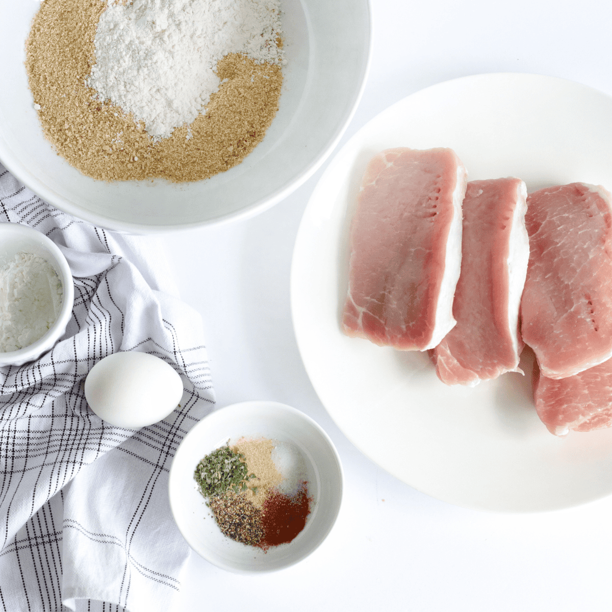 Ingredients needed for Cracker Barrel Country Fried Pork Chops on kitchen table.
