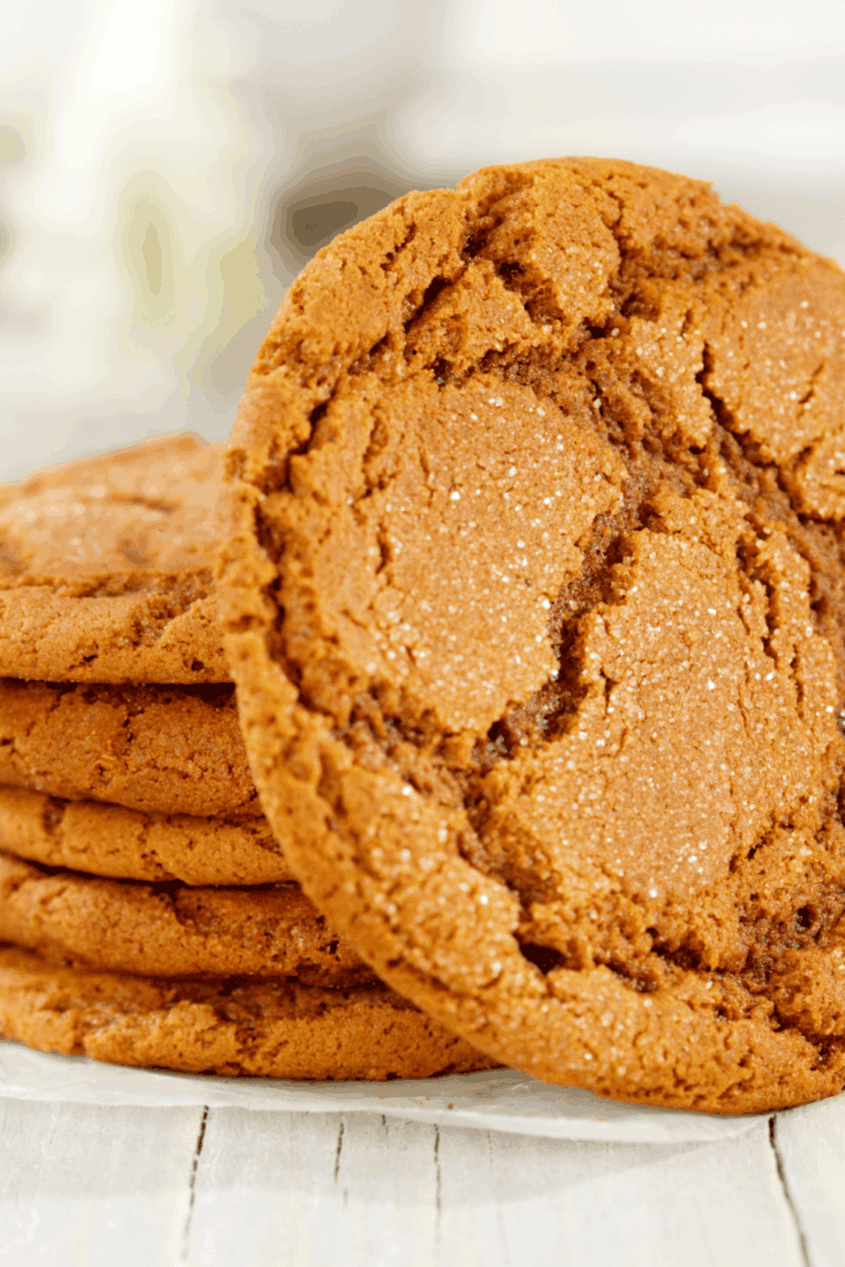 Freshly baked soft and chewy gingersnap cookies in an air fryer, golden brown with a dusting of sugar.
