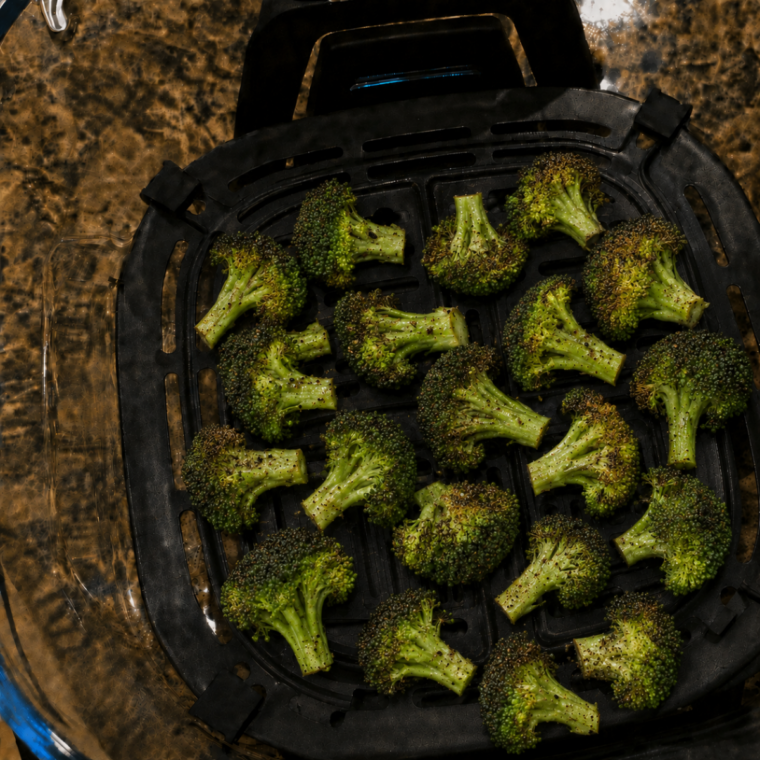 Cooked broccoli stored in the Ninja Crispi glass container with the lid on