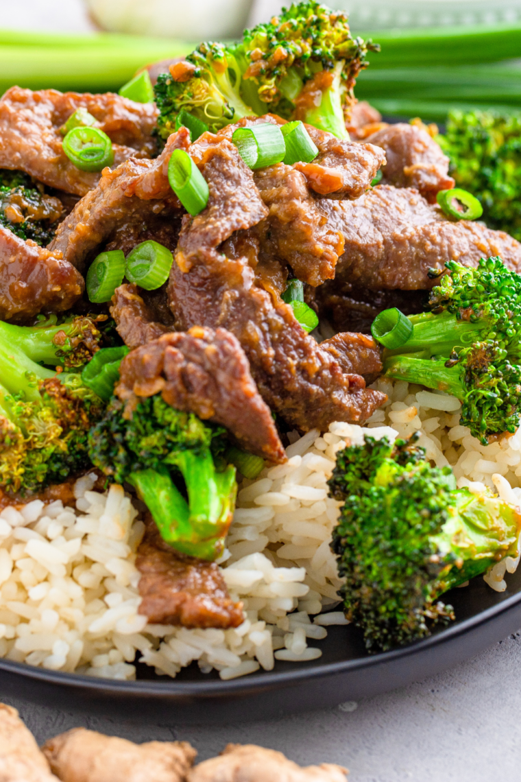 Crispy broccoli florets plated with garlic butter steak bites made in the Ninja Crispi