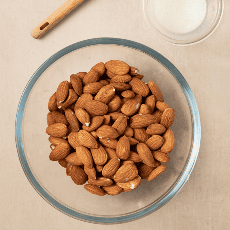 Ingredients for air fryer roasted almonds: raw whole almonds, olive oil, and sea salt