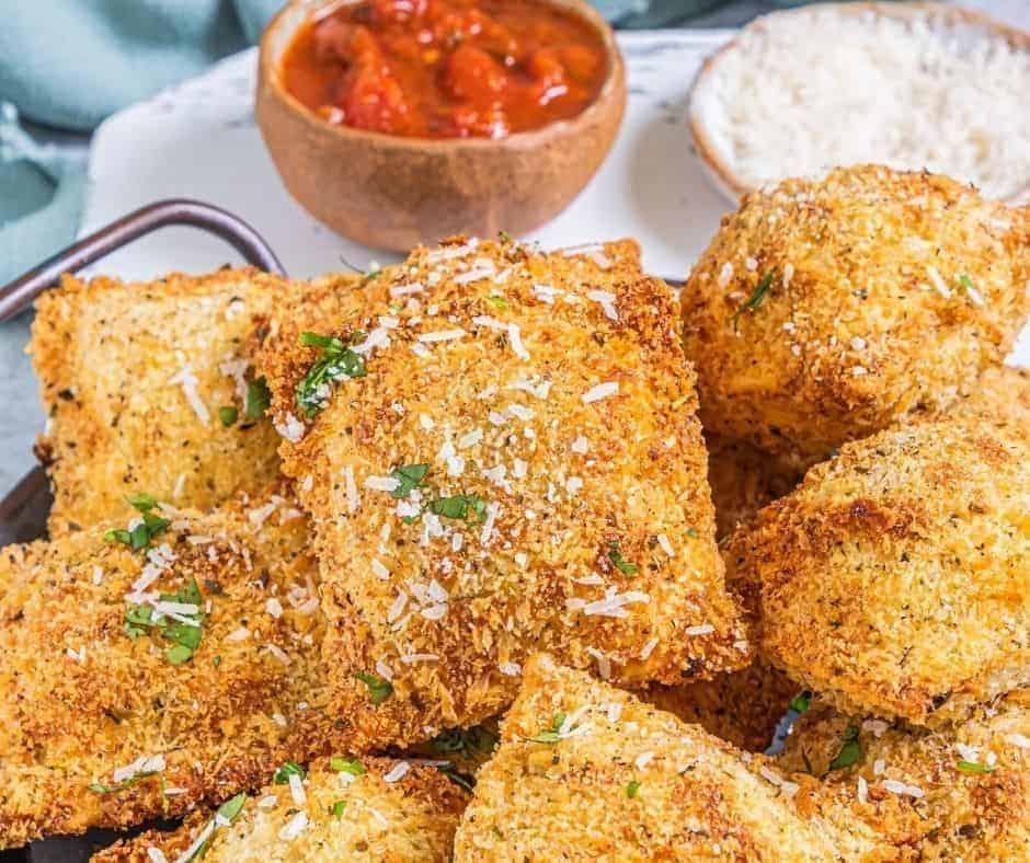 Golden and crispy Air Fryer Olive Garden Toasted Ravioli served with marinara sauce, perfect for an appetizer or snack."